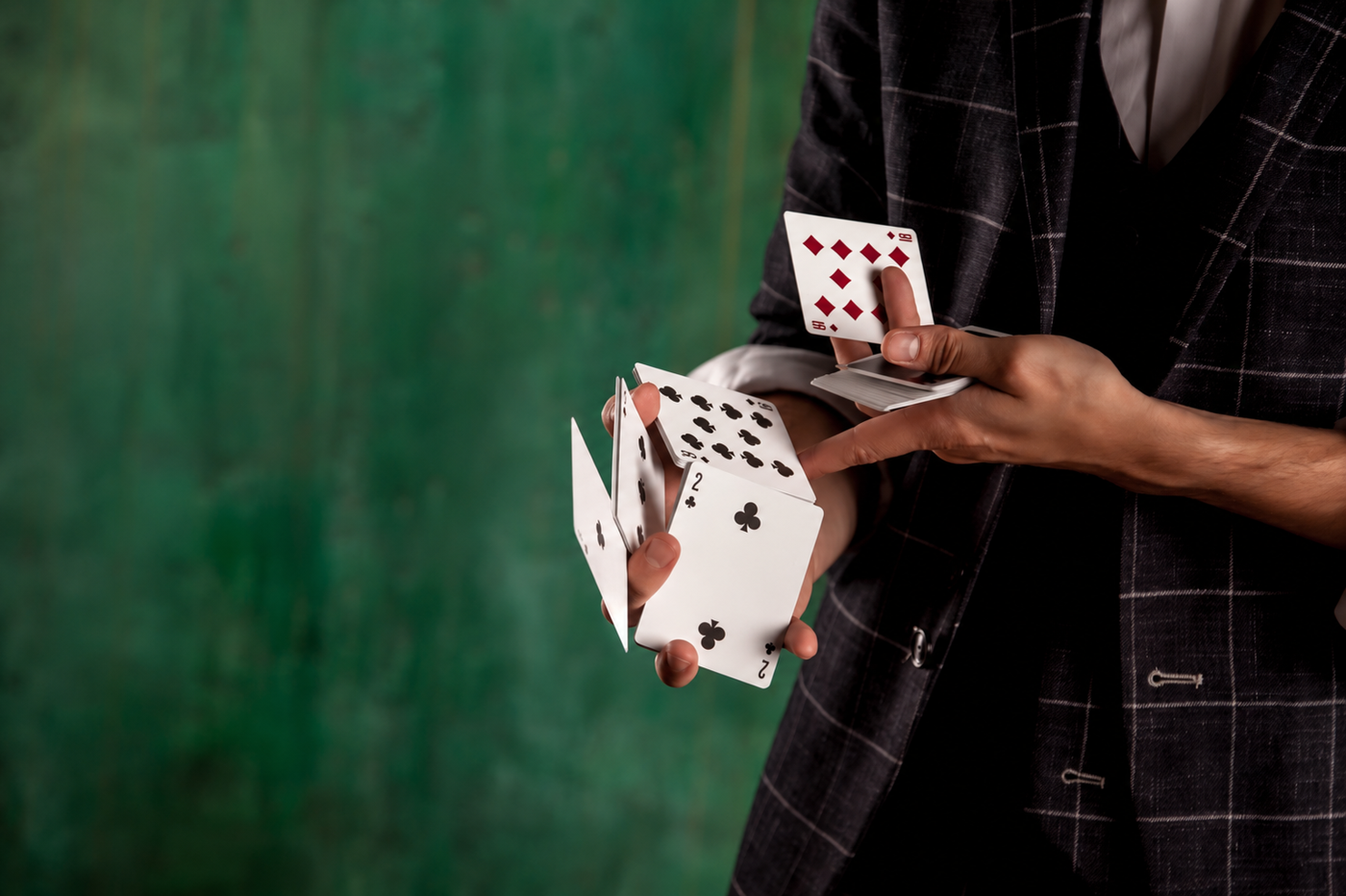 Magician fanning playing cards between his hands